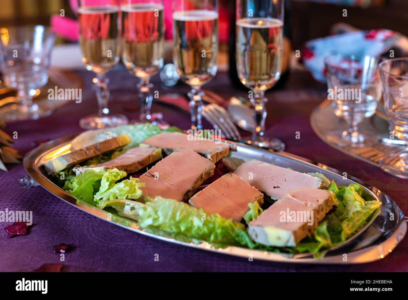 Traditional french gourmet foie gras platter served with champagne glasses for Christmas or New Year's Eve dinner. Stock Photo