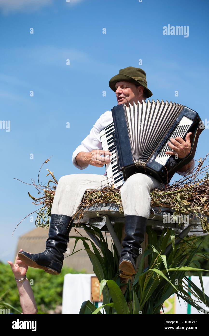 The accordion is played by a Slavic Belarusian or Ukrainian in nati ...