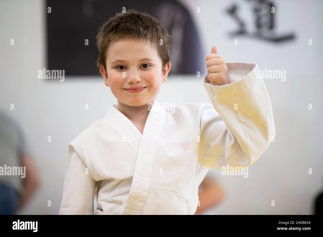 Belarus, the city of Gomel, June 23, 2021. Judo club. A child in a kimano shows a class sign. Stock Photo