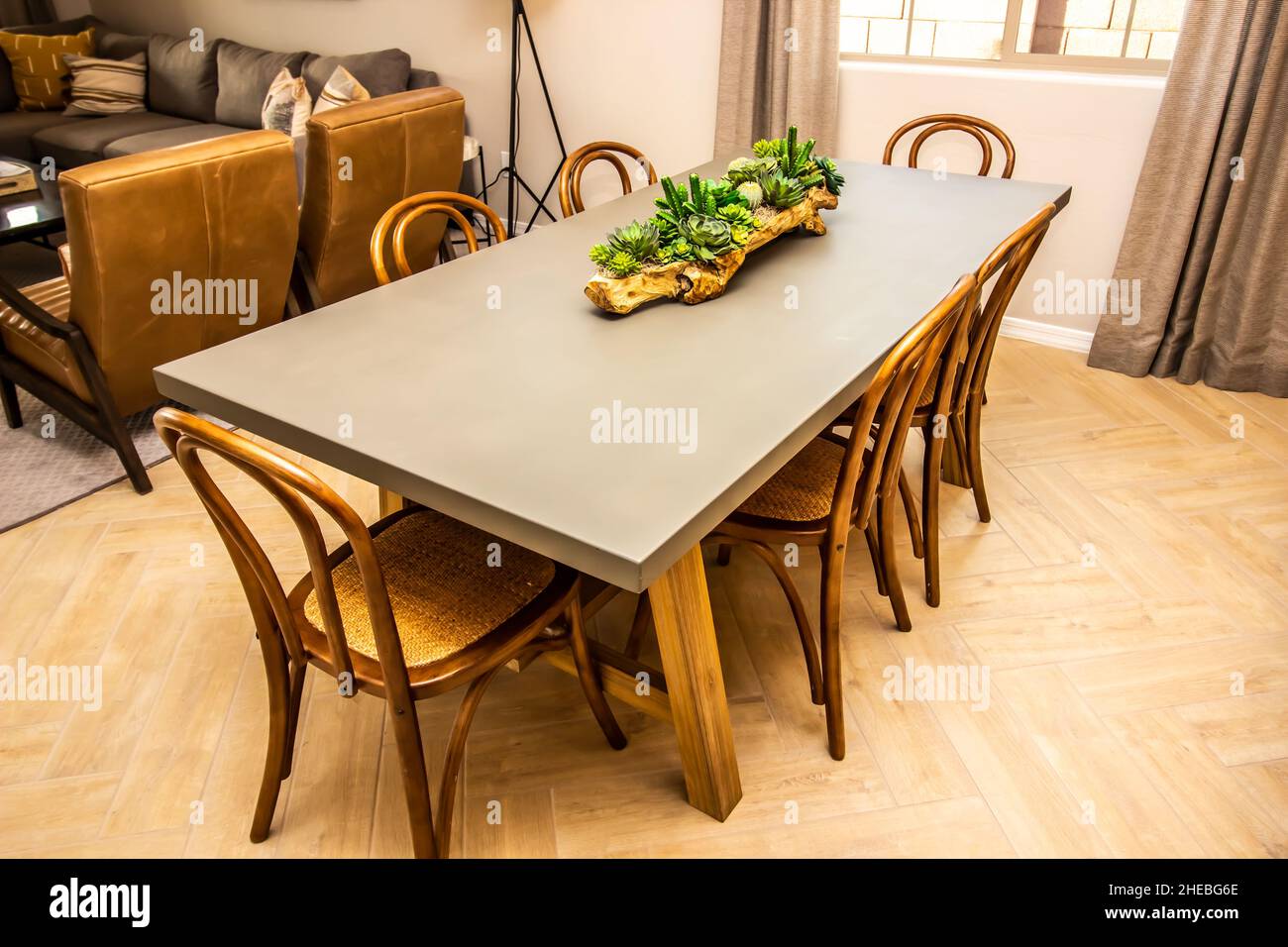 Wooden Dining Area Table With Can Back Chairs Stock Photo - Alamy
