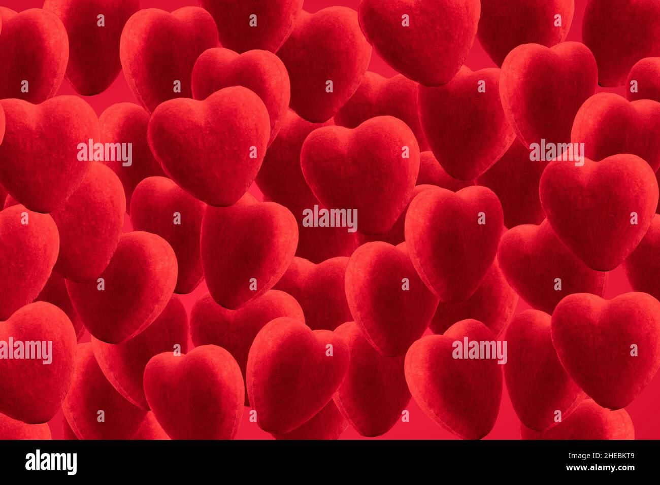 red background of plush hearts. red hearts are a symbol of happy valentine's day, love relationships and weddings. Stock Photo