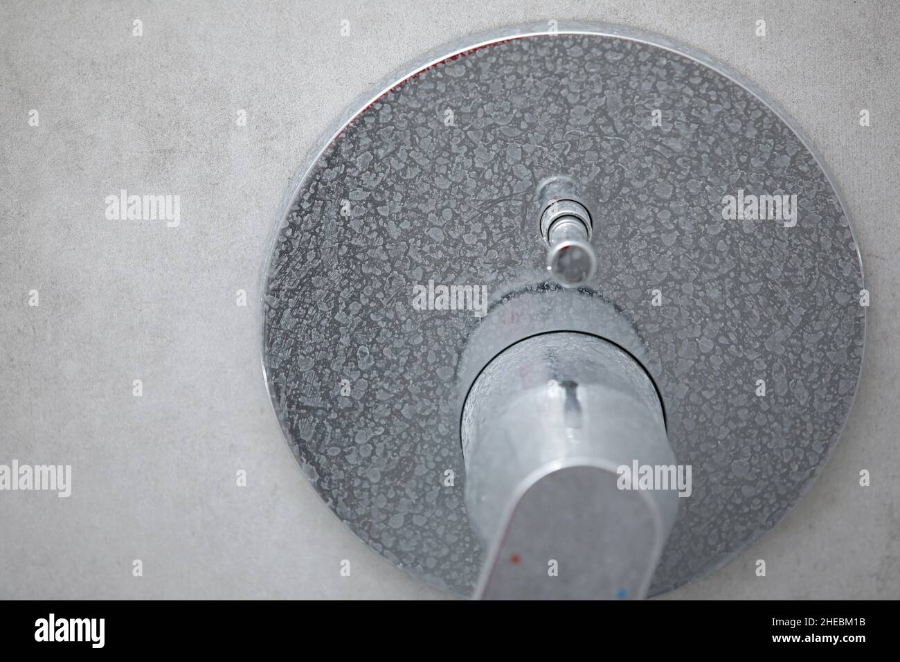 Dirty calcified shower mixer tap, faucet with limescale on it, plaque