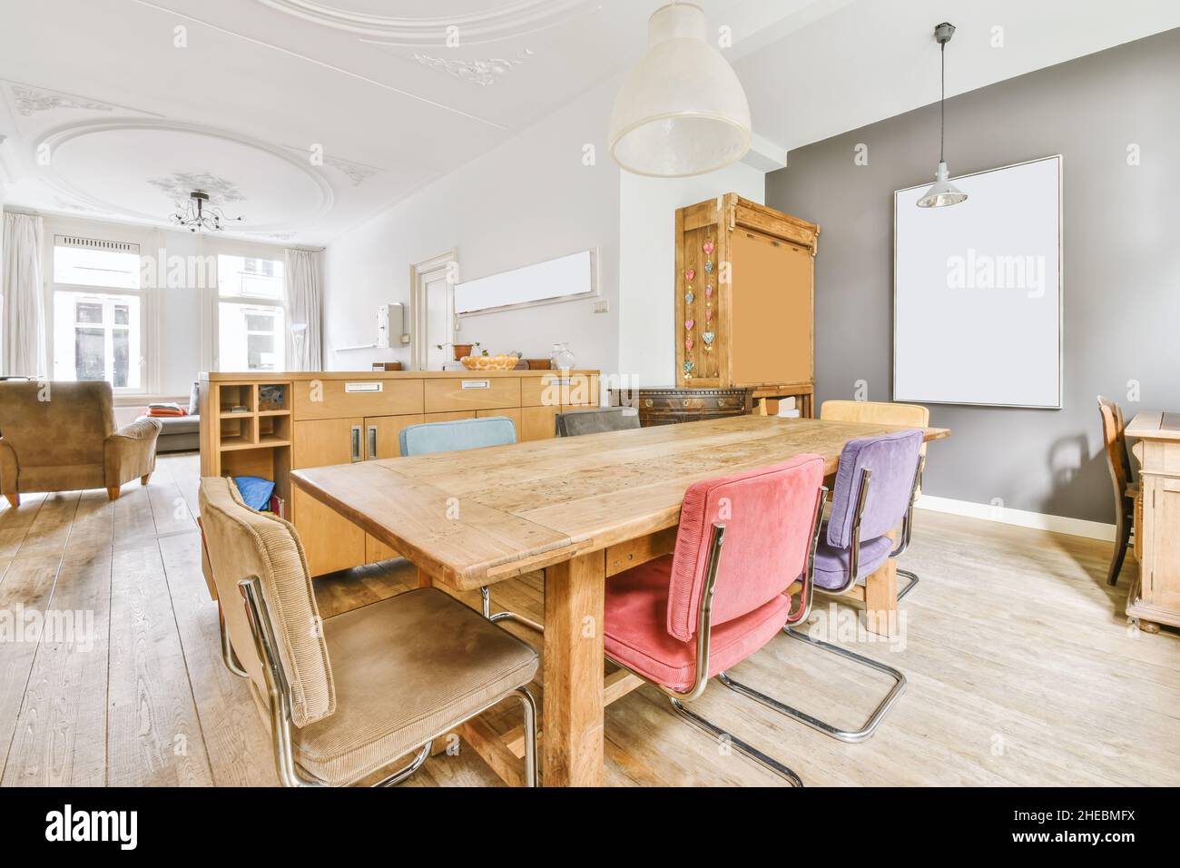 Amazing dining room with wood table and painting on the wall Stock