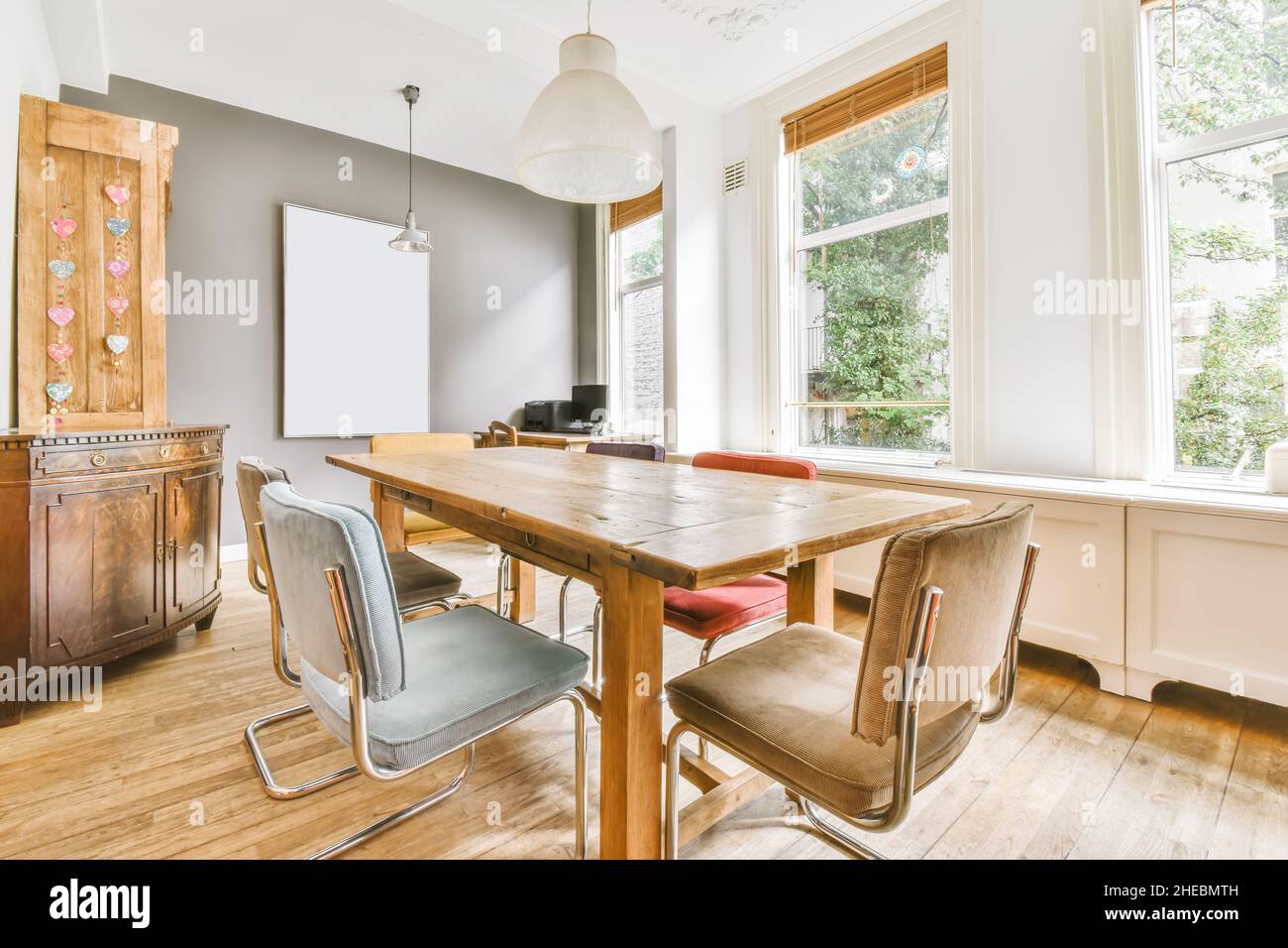 Amazing dining room with wood table and painting on the wall Stock