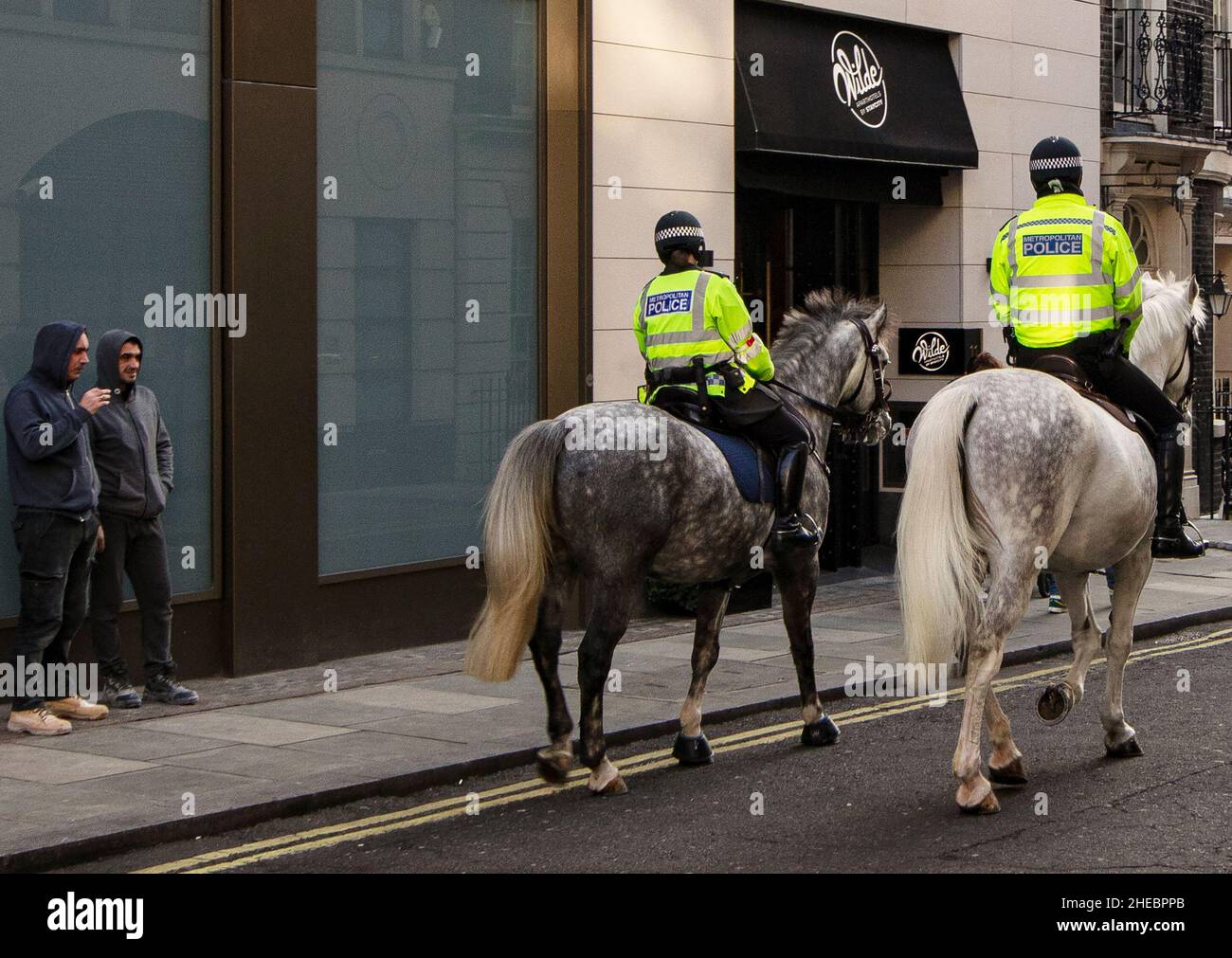 Two Mounted Policemen On Police Horses In Central London Watched By Two two-mounted-policemen-on-police-horses-in-central-london-watched-by-two
