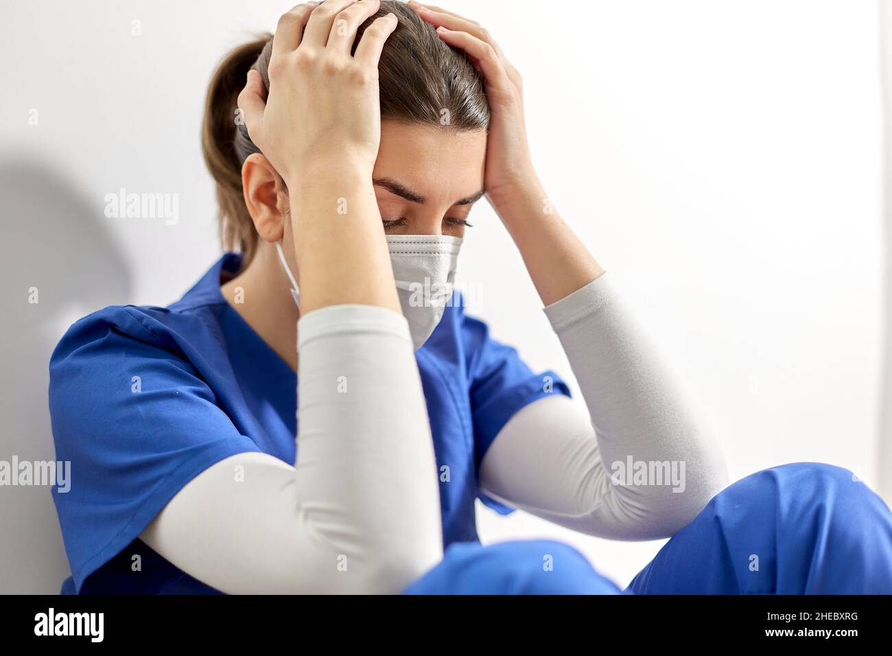 Tired young nurse holding hi-res stock photography and images - Alamy