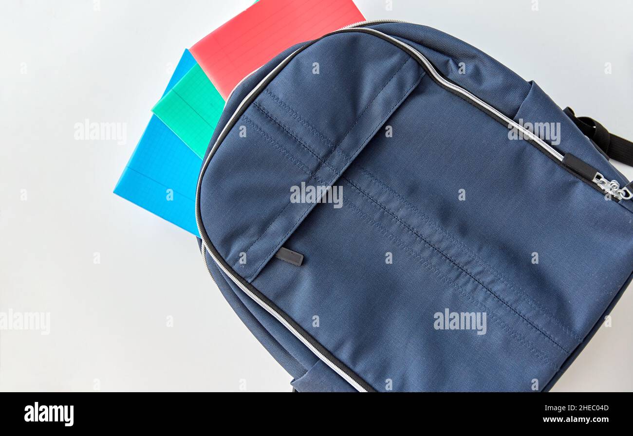 school backpack with notebooks on table Stock Photo