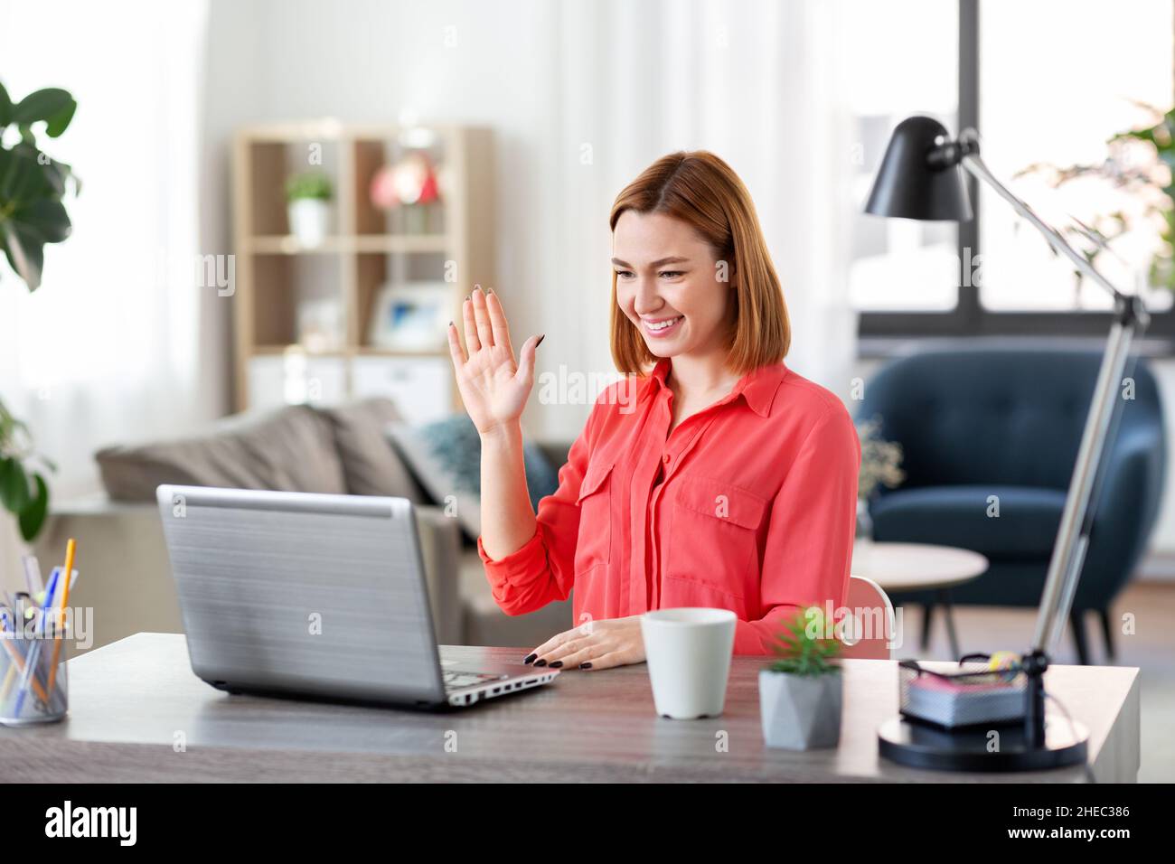 woman with laptop having video call at home office Stock Photo - Alamy