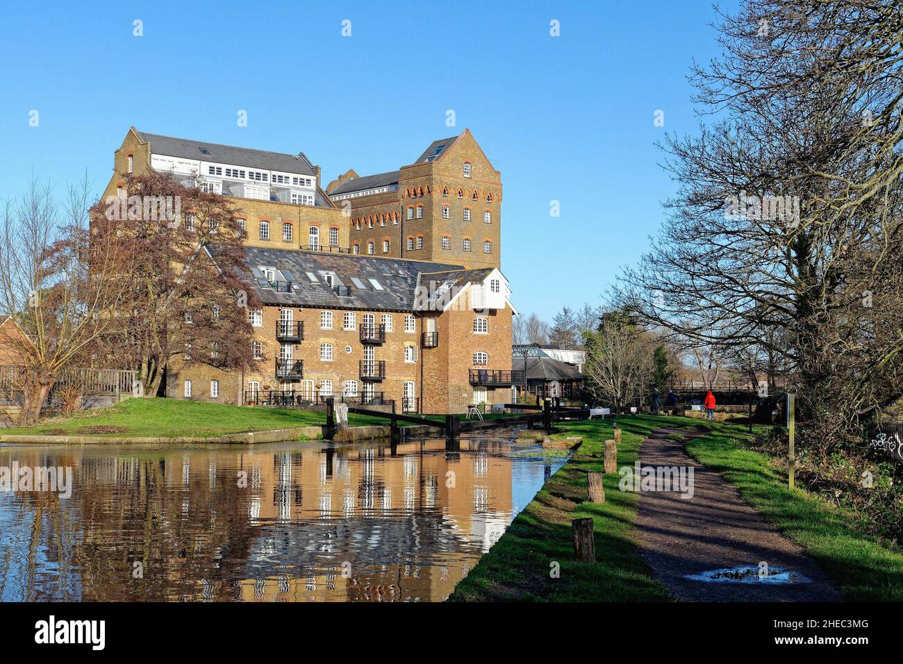 Coxes Lock Mill apartments on the River Wey Navigation canal on a sunny