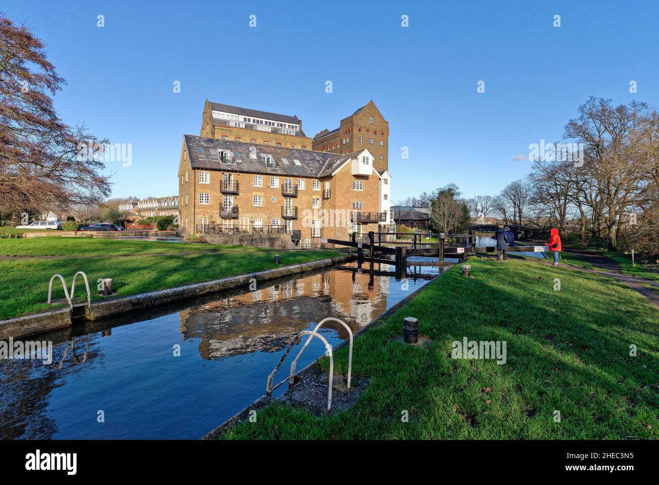 Coxes Lock Mill apartments on the River Wey Navigation canal on a sunny