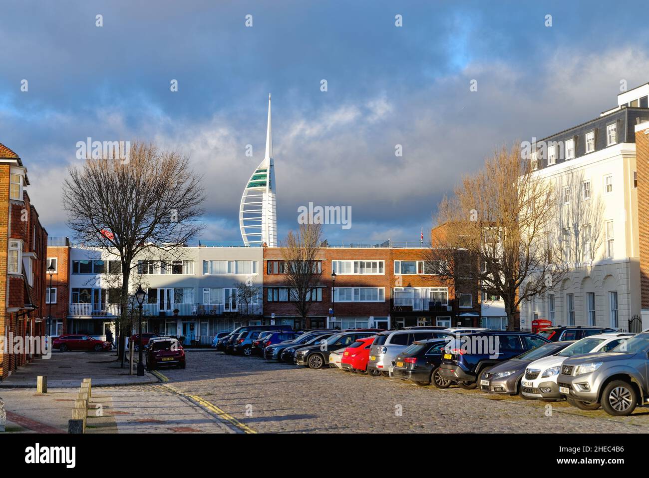 The Spinnaker Tower looming over the skyline of old Portsmouth at Grand Parade  illuminated by a dramatic winter sunset, Hampshire England UK Stock Photo