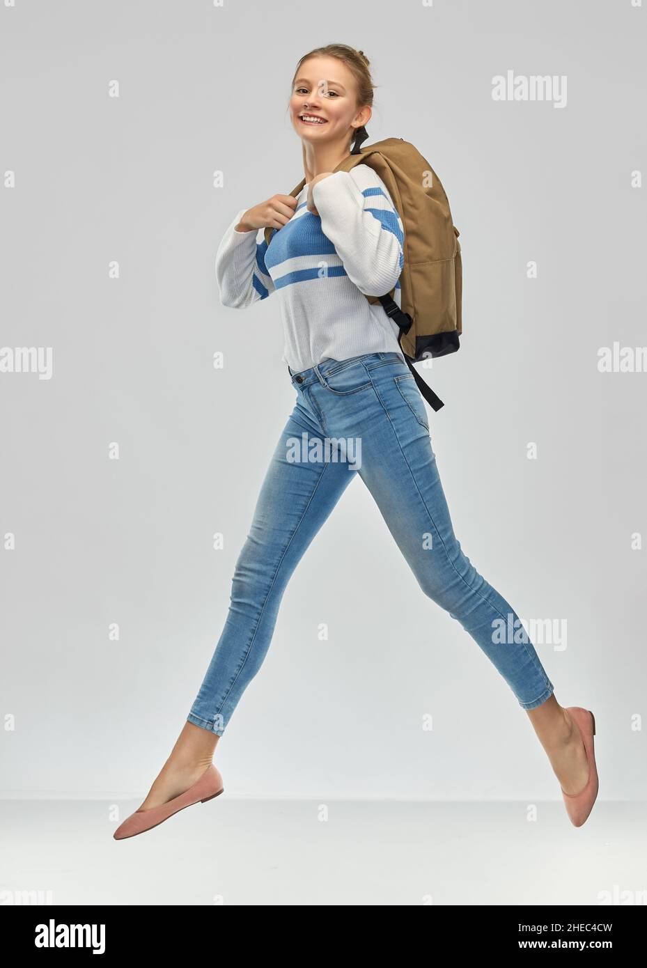 happy teenage student girl with school bag jumping Stock Photo - Alamy