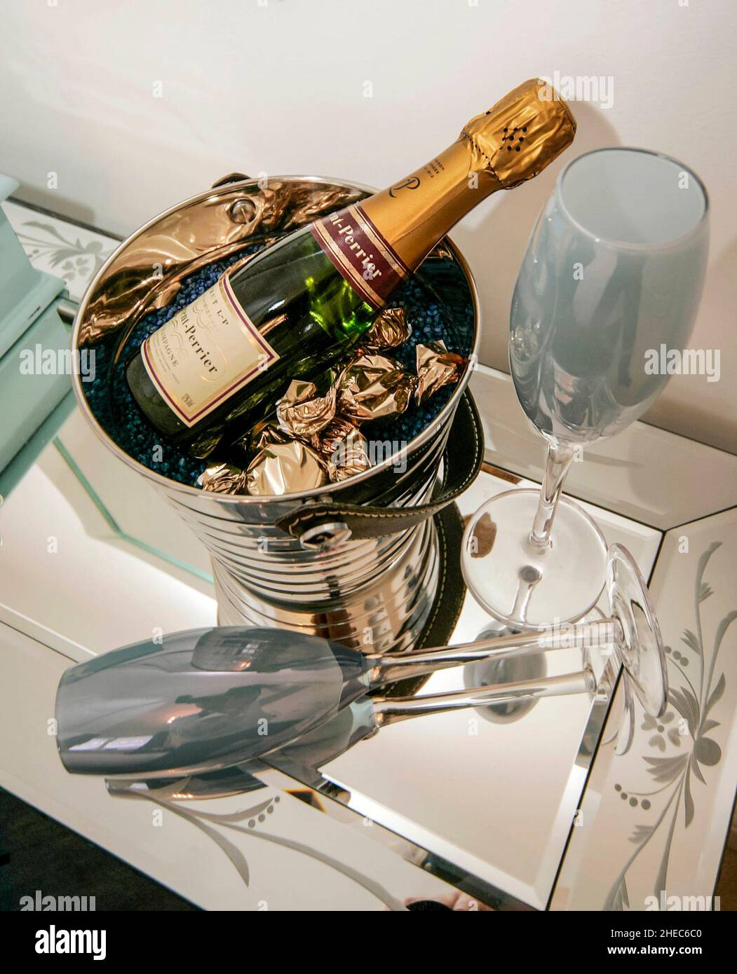 Bottle of LaurentPerrier champagne in a bucket, with two glasses, all