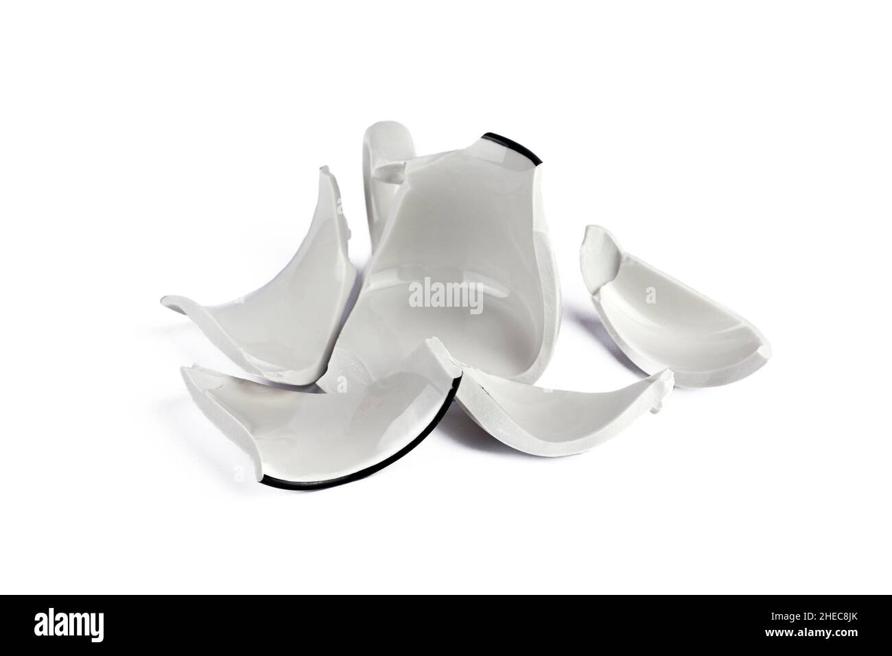 Broken white cup on white background. Concept disintegration, mockup Stock Photo