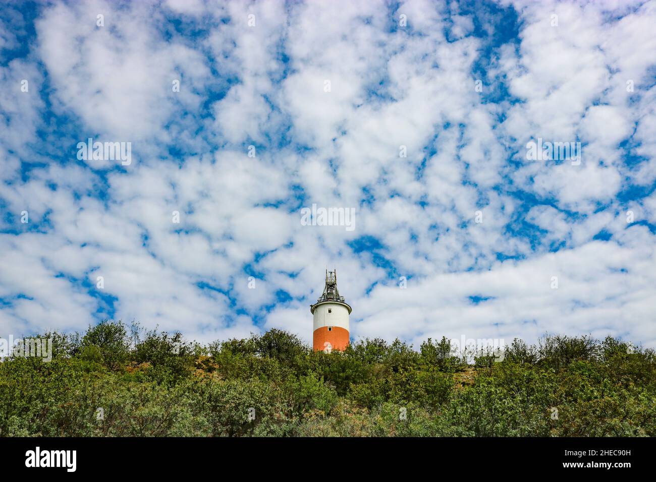 Lighthouse on the mountain against a background of blue sky and cirrus clouds. Stock Photo