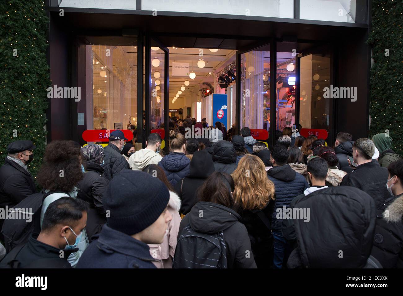 People enter Selfridges department store at the time of opening on