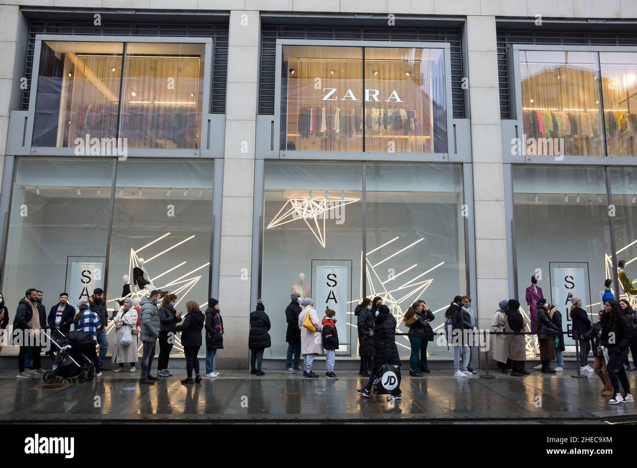 People queue outside a Zara store on Boxing Day in central London as