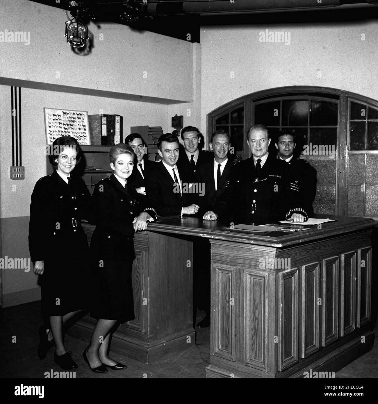 1966 file photo of Nicholas Donnelly, who has died aged 83, with the the cast of the BBC series 'Dixon of Dock Green,' from left, Jean Dallas, Anne Carroll, Joe Dunlop, Peter Byrne, Nicholas Donnelly, Geoffery Adams, Jack Warner (Dixon) and Ronald Bridges. As well as appearing as Sergeant Johnny Wills in around 200 episodes, he played teacher Mr MacKenzie in Grange Hill for around eight years of the TV show. Stock Photo