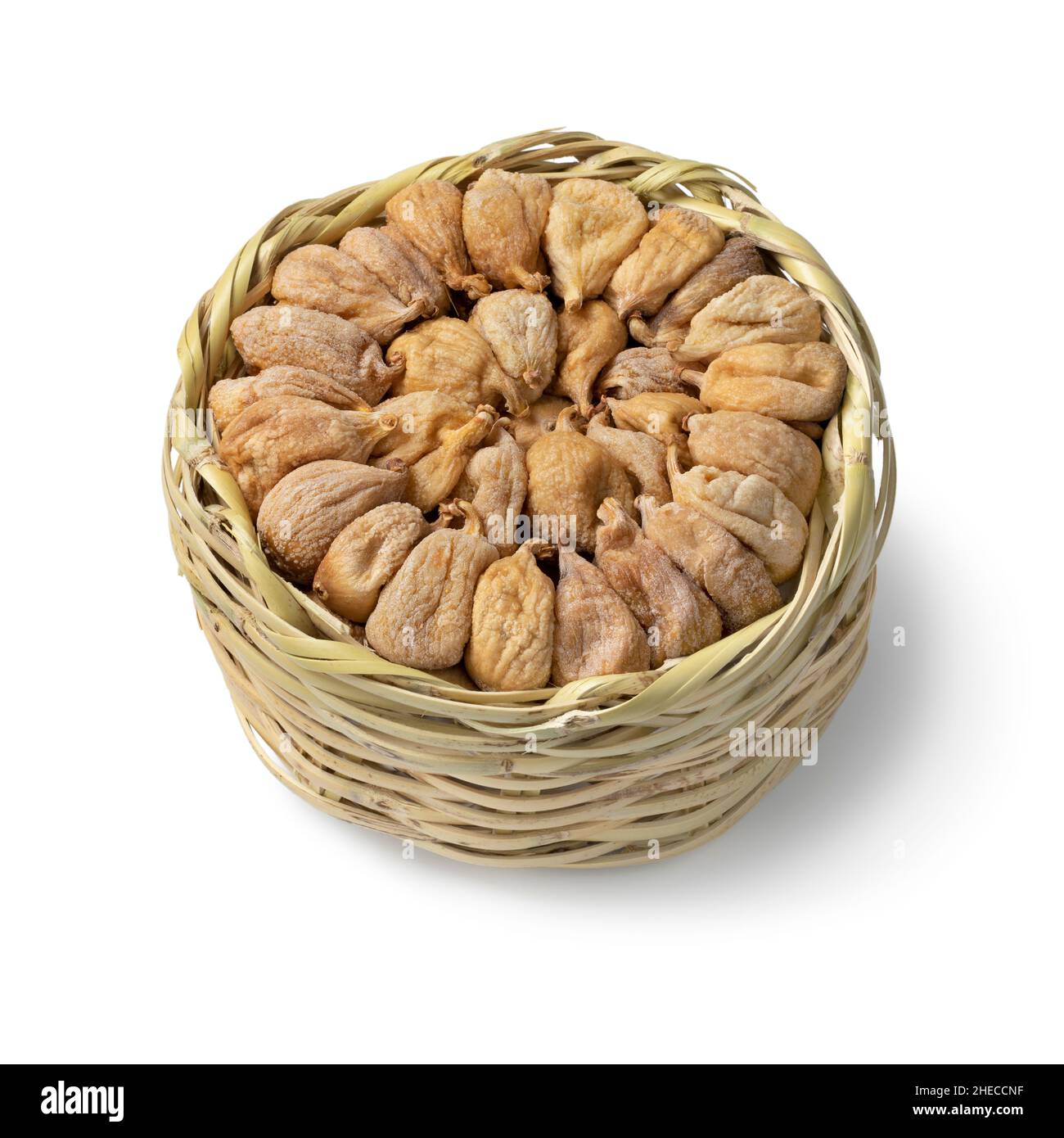 Traditional dried Turkish figs in a basket close up isolated on white