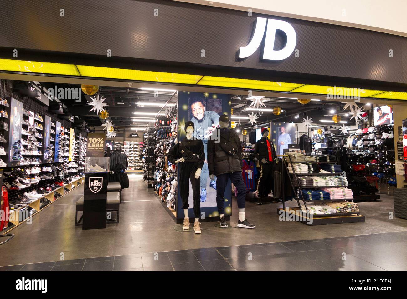 JD Sports shop with open walk in display and sign of the airside retail
