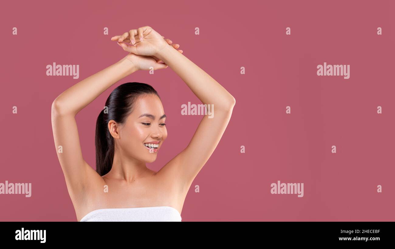 Happy japanese woman showing her clean and hairless armpits Stock Photo