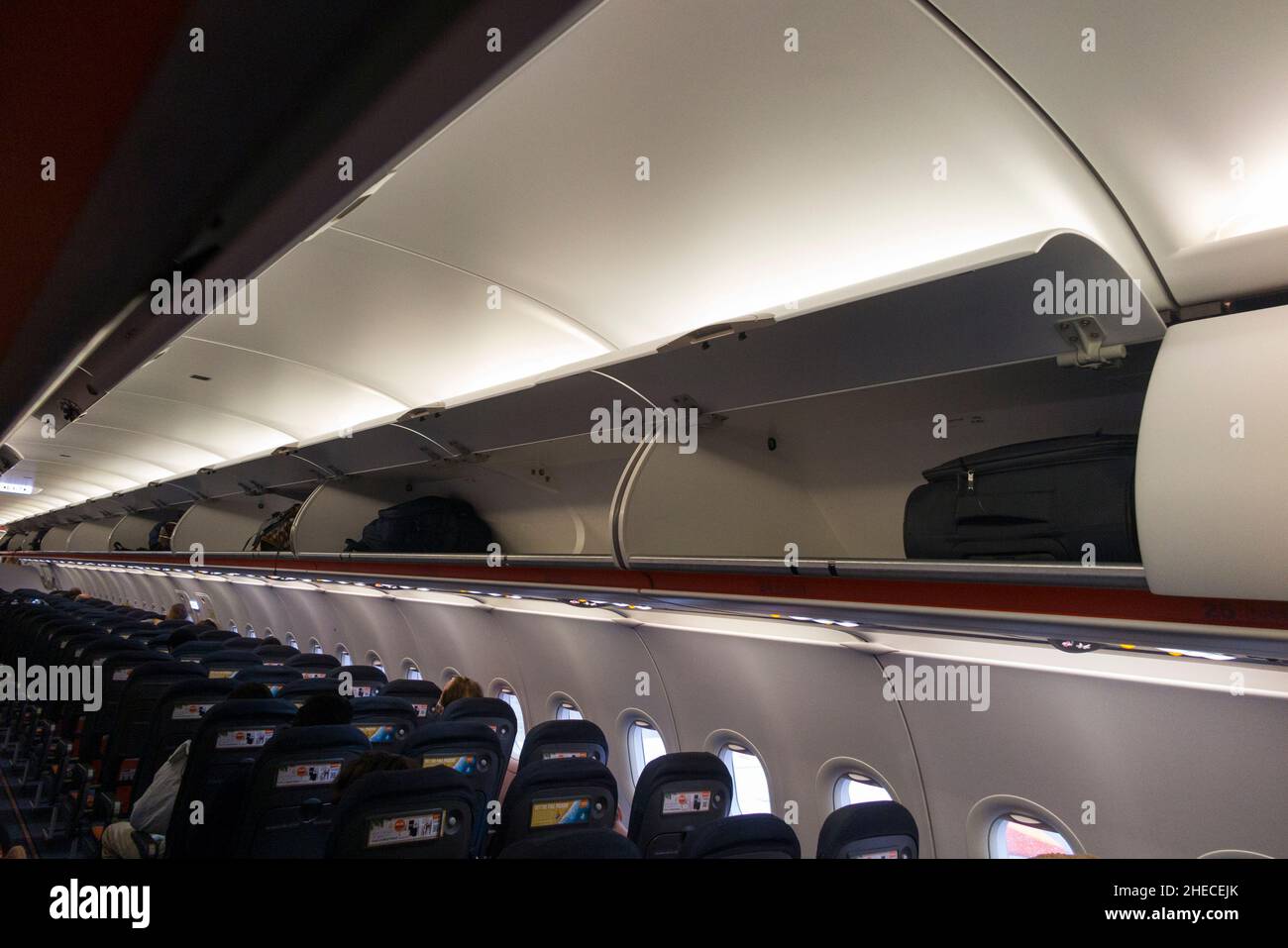 Overhead passenger locker / lockers / compartment / compartments for stowing passengers bags cabin luggage, on an Easyjet Airbus A320 or A319 plane.  (128) Stock Photo