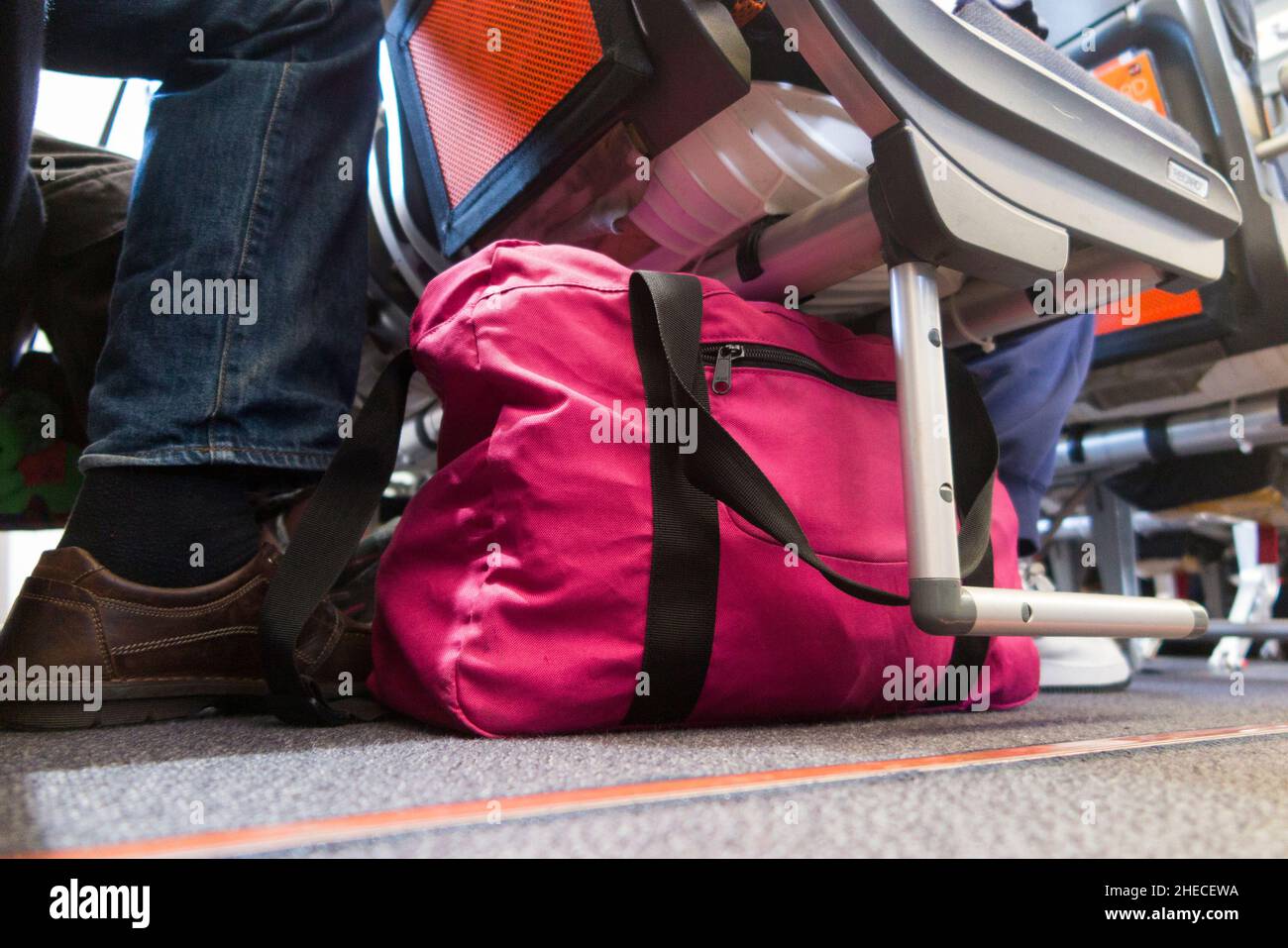 Bag under passenger seat storage area for passengers for stowing hand luggage bags & carry on cabin baggage item. Easyjet Airbus A320 /  A319 plane. (128) Stock Photo