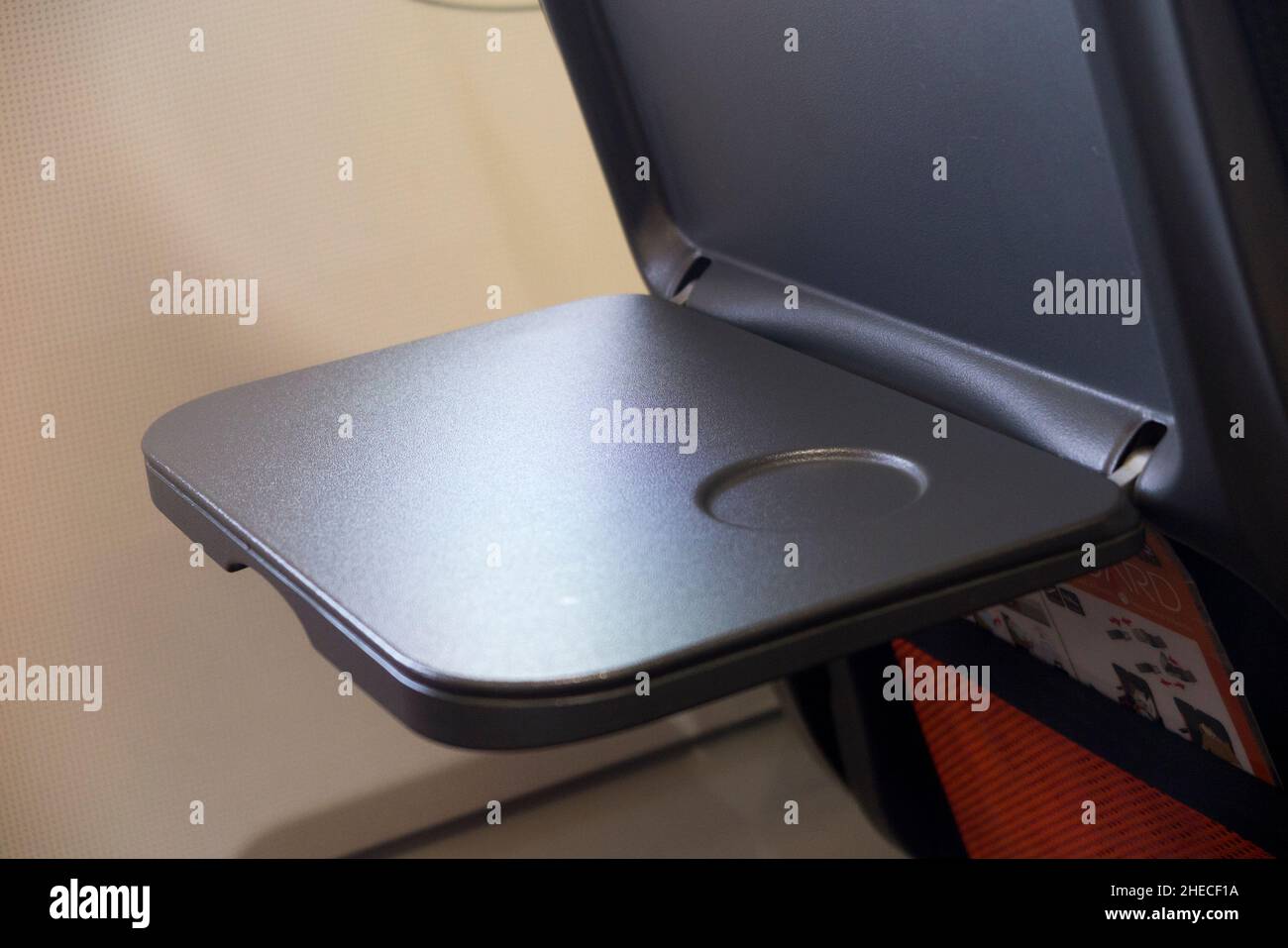 Passenger seat tray table in the full down position ready for use, on an Airbus A320 or A319 plane / airplane aeroplane operated by Easyjet. (128) Stock Photo