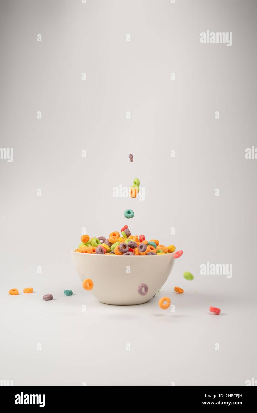 Colorful cereal box for morning breakfast. Corn flakes falling to the