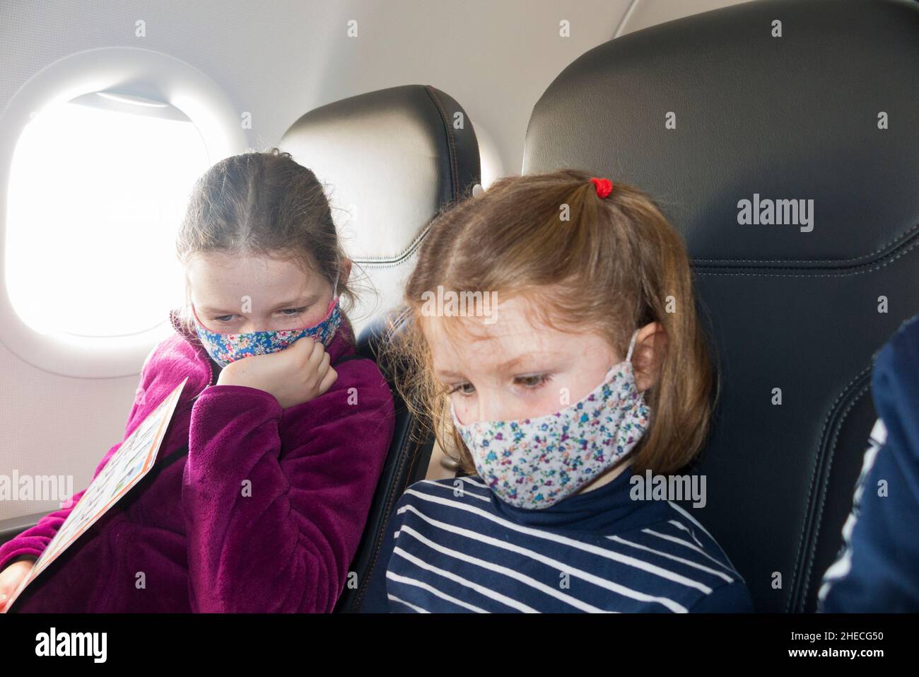 Child siblings children wearing face covering masks against COVID19 / two sisters aged 9 & 5