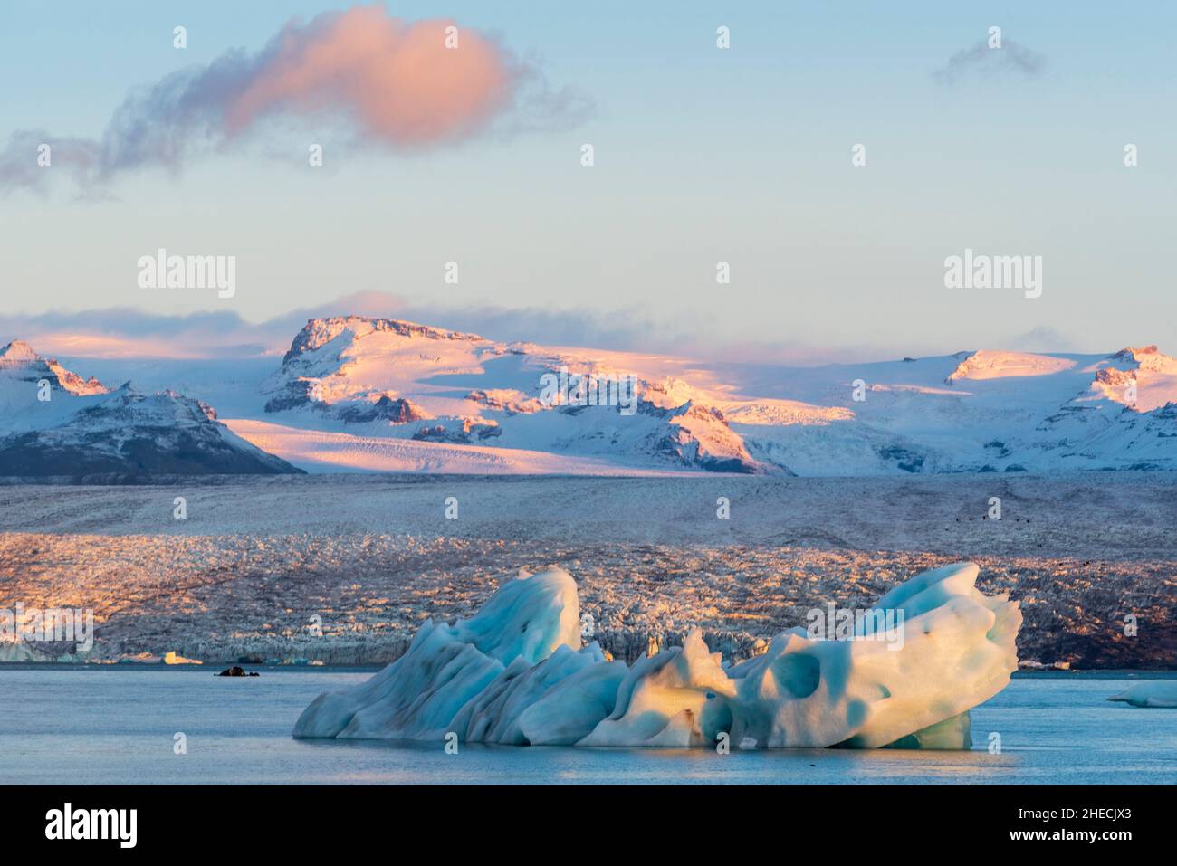 Iceland, Austurland, Vatnajokull National Park, iceberg floating in the glacial lagoon of Jokulsarlon at sunrise Stock Photo