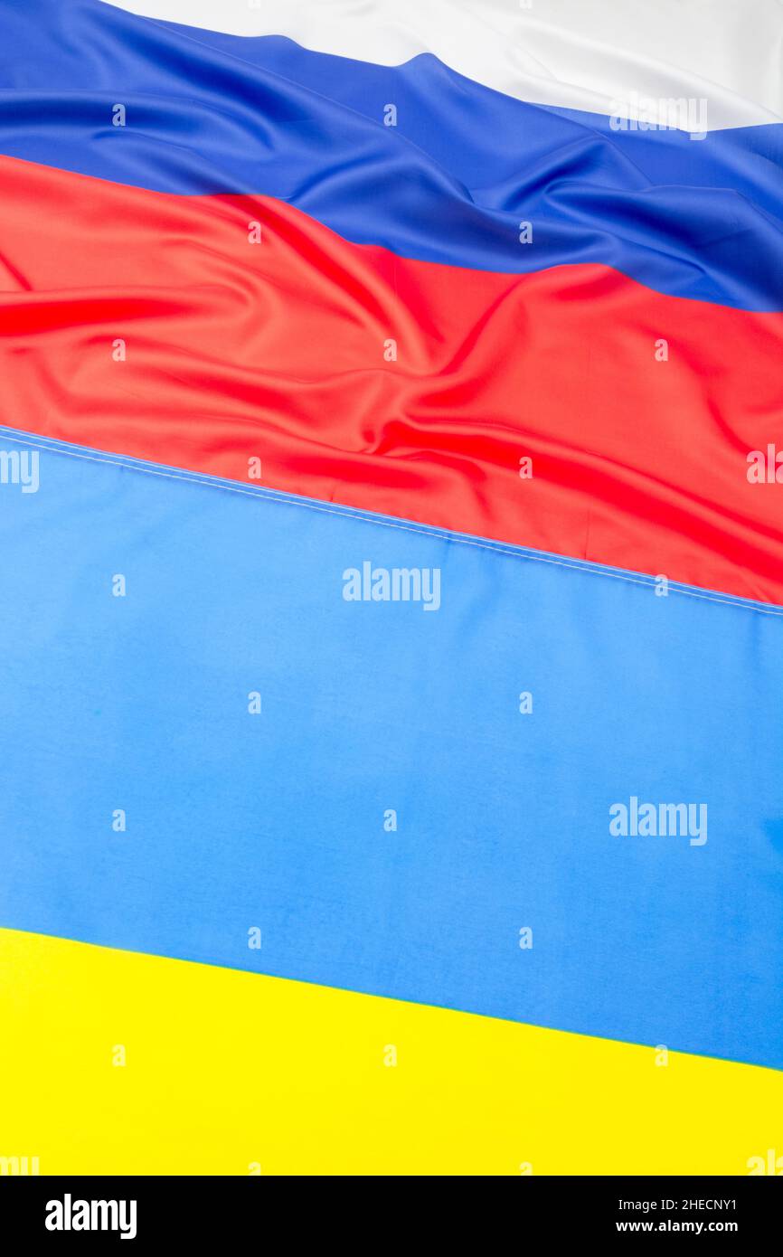 Polyester Russian and Ukrainian flags for Ukraine-Russia crisis, Russia Ukraine invasion, tensions and war in Ukraine. Russian flag ruffled. Stock Photo