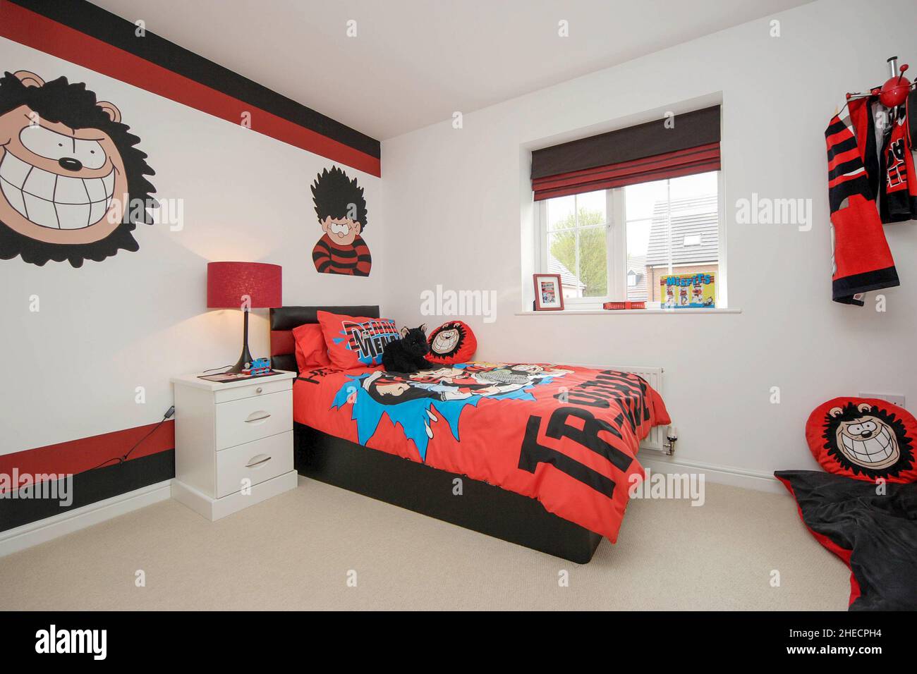 Childs boys bedroom,Dennis the Menace theme,bed,wall decor,lifestyle,Gnasher the dog. Stock Photo