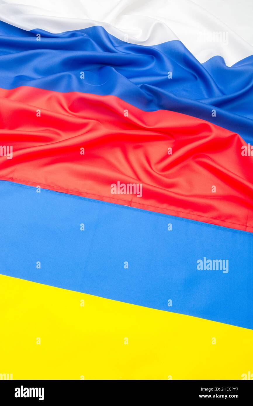 Polyester Russian and Ukrainian flags for Ukraine-Russia invasion, Russian invasion, tensions and war in Ukraine. Russian flag ruffled. Stock Photo