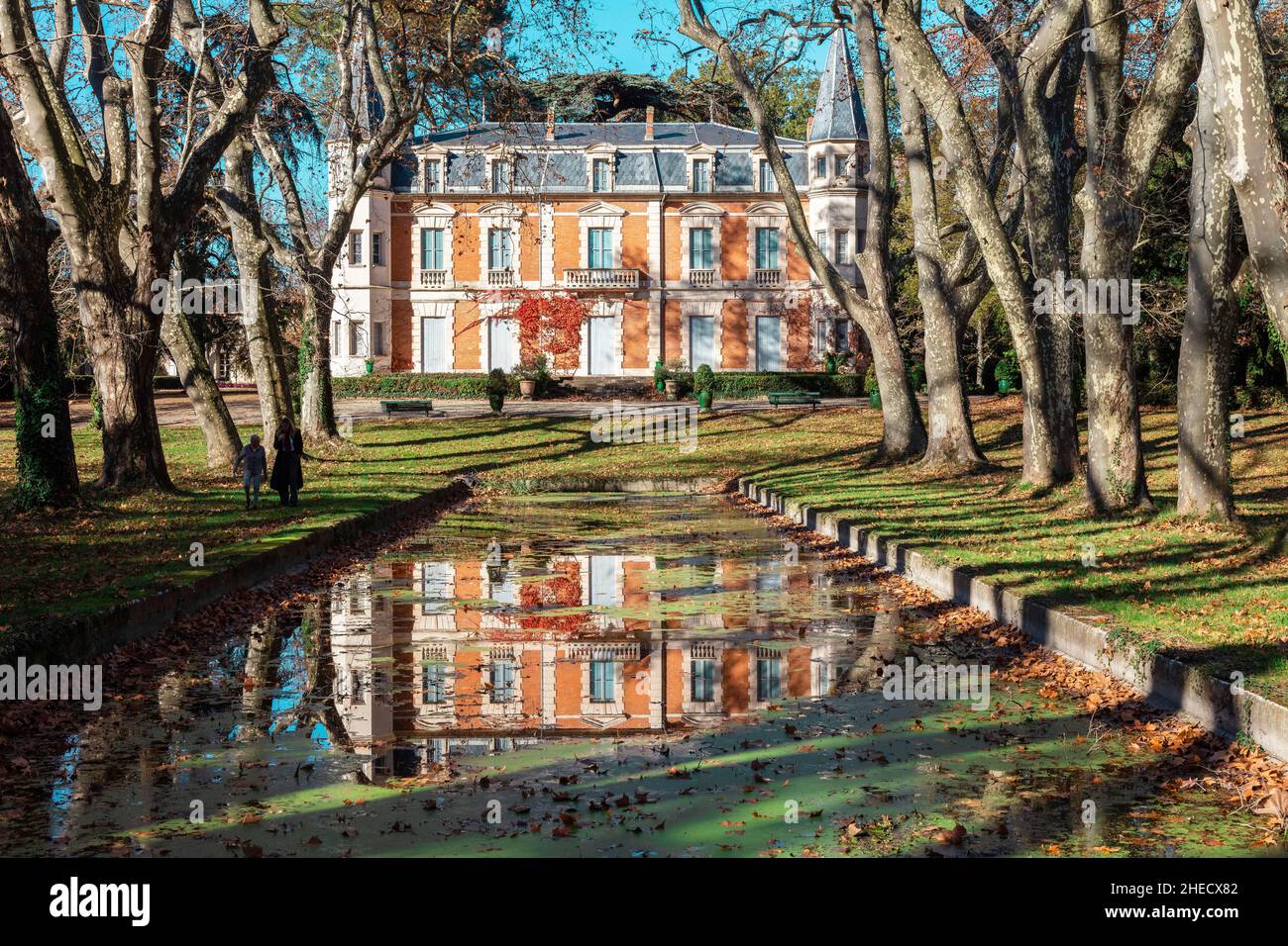 France, Herault, Pezenas, reflection of a castle in a pond in a wooded park Stock Photo