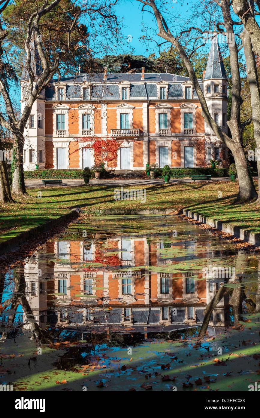 France, Herault, Pezenas, reflection of a castle in a pond in a wooded park Stock Photo