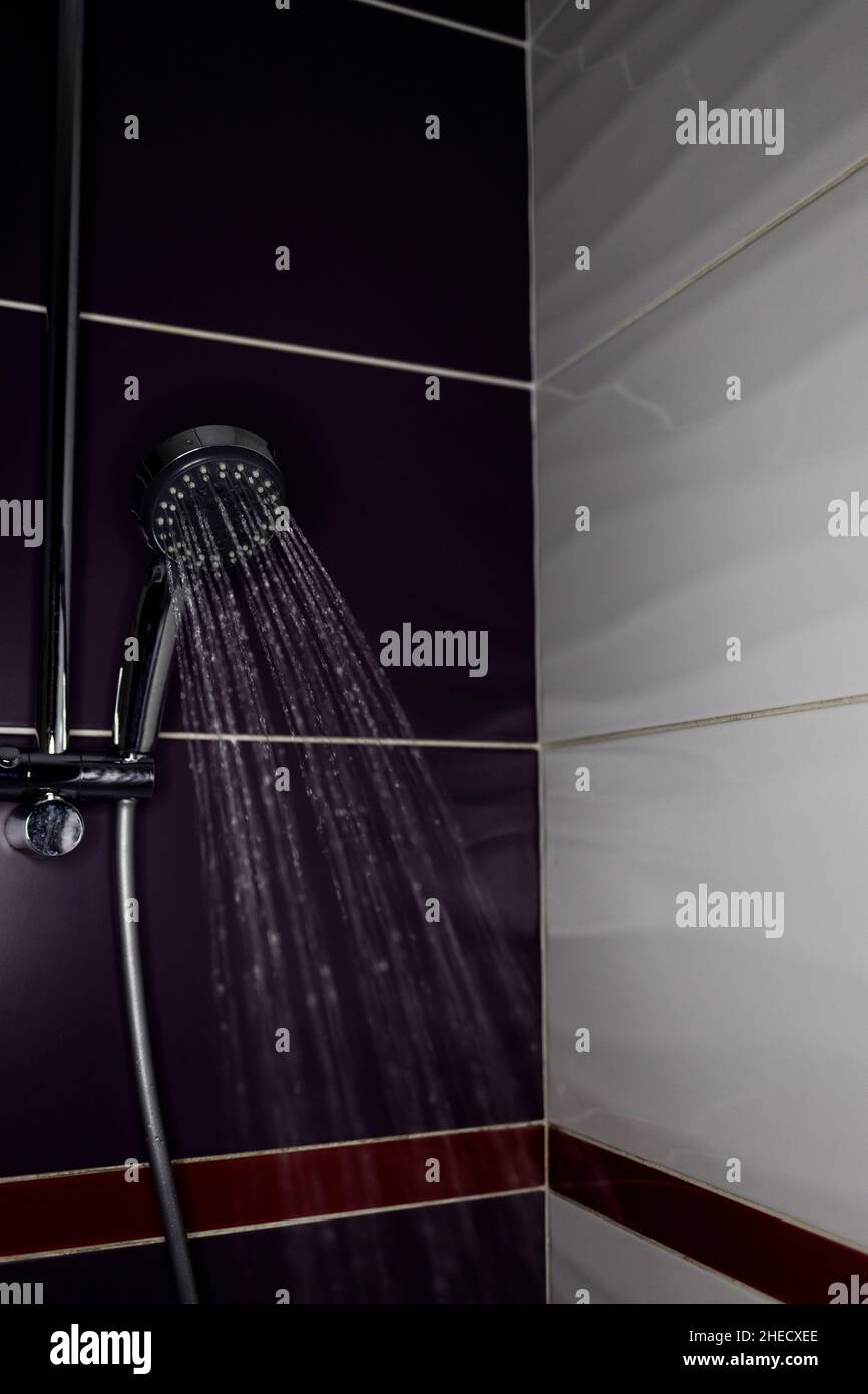 Fresh shower behind wet with water drops splashing. Water running from