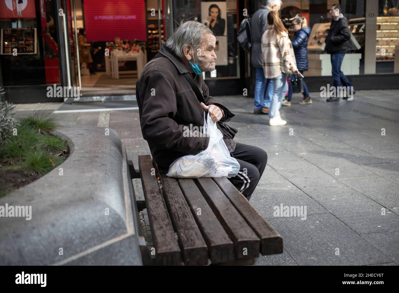 Belgrade, Serbia, Jan 5, 2022: Portrait of a senior citizen sitting on a bench in Knez Mihailova street Stock Photo