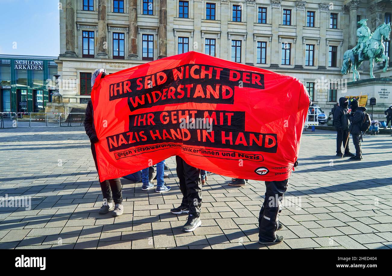 Braunschweig, Germany, January 8, 2022: Poster against Corona demonstrators protesting with Nazis and neo-Nazis against Corona rules Stock Photo