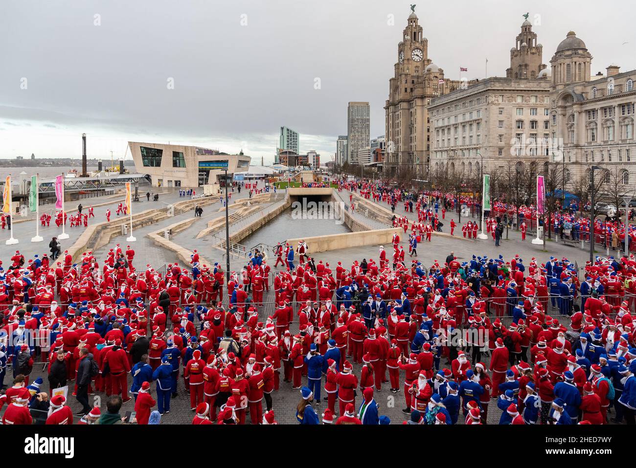 Liverpool, UK: Santa Dash participants lining up before the start on the city waterfront. Stock Photo