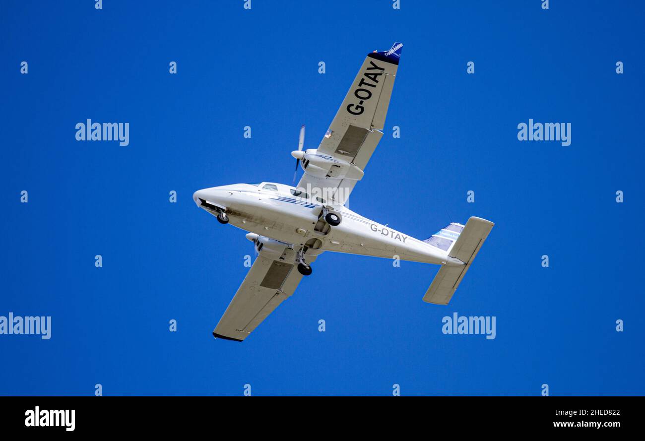 Tayside Aviation's Italian high-winged twin-engine plane, G-OTAY Tecnam P-2006T is flying overhead preparing to land at Dundee Airport in Scotland, UK Stock Photo
