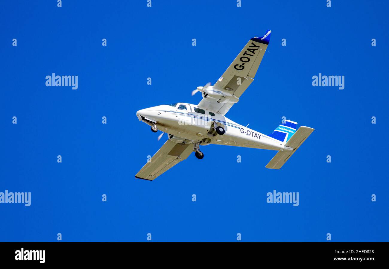 Tayside Aviation's Italian high-winged twin-engine plane, G-OTAY Tecnam P-2006T is flying overhead preparing to land at Dundee Airport in Scotland, UK Stock Photo