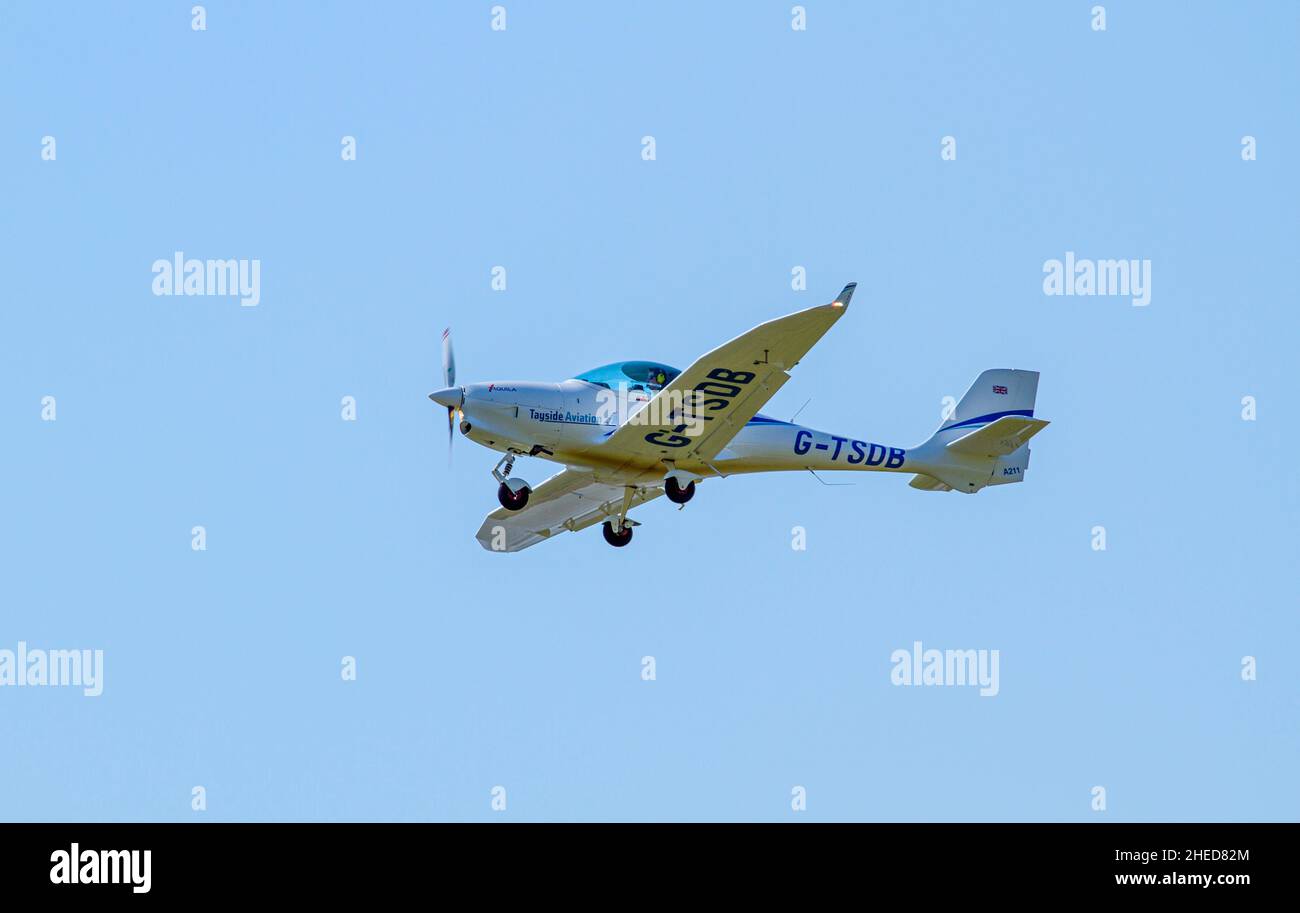 Tayside Aviation G-TSDB Aquila 211, a German-made light aircraft is flying overhead as it prepares to land at Dundee Airport in Scotland, UK Stock Photo
