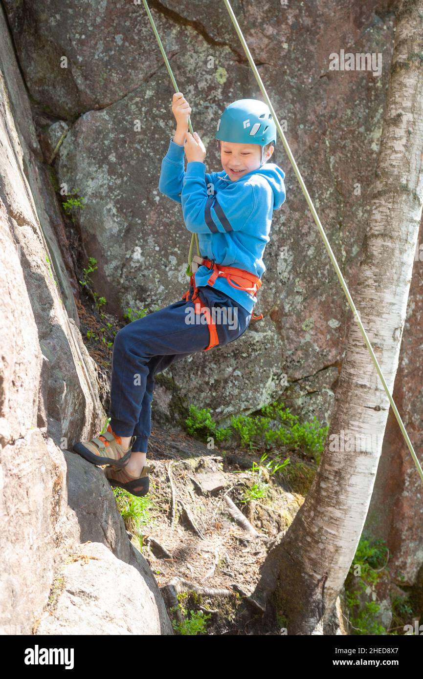 Family rock climbing at Kvarnby climbing area near Helsinki, Finland Stock Photo