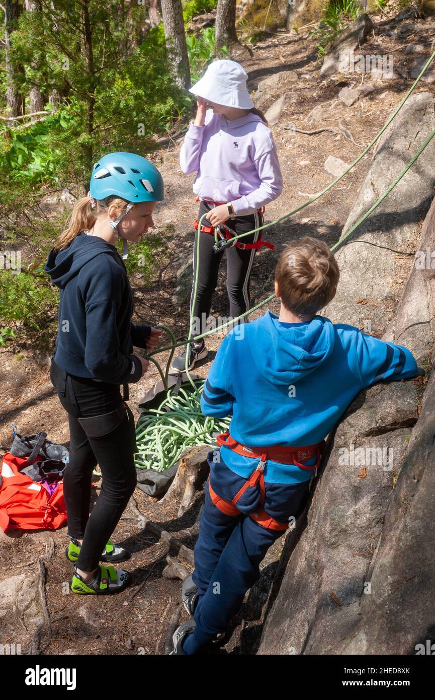 Family rock climbing at Kvarnby climbing area near Helsinki, Finland Stock Photo