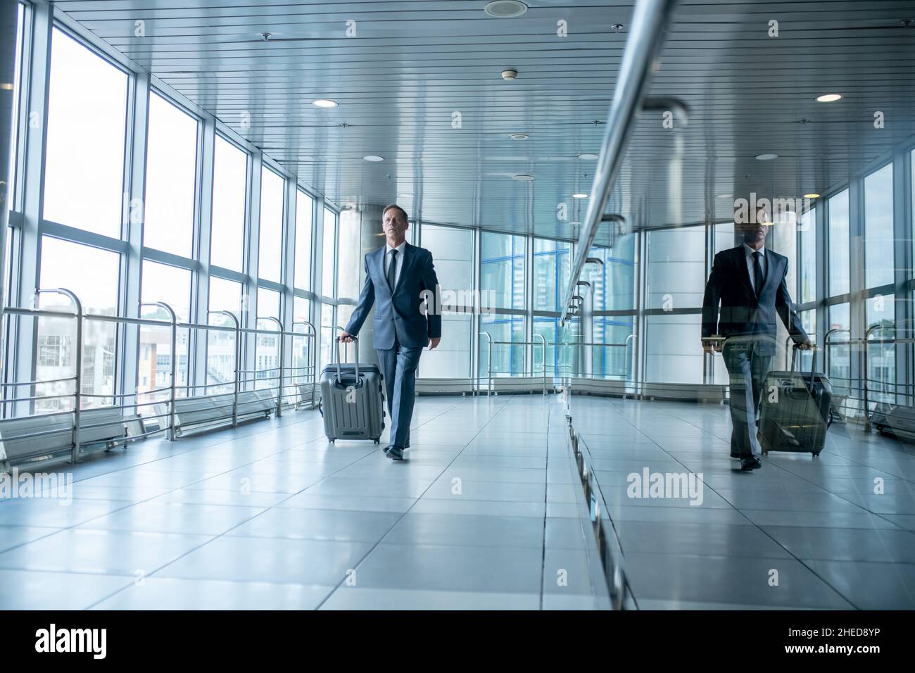 Male passenger with the baggage walking ahead Stock Photo