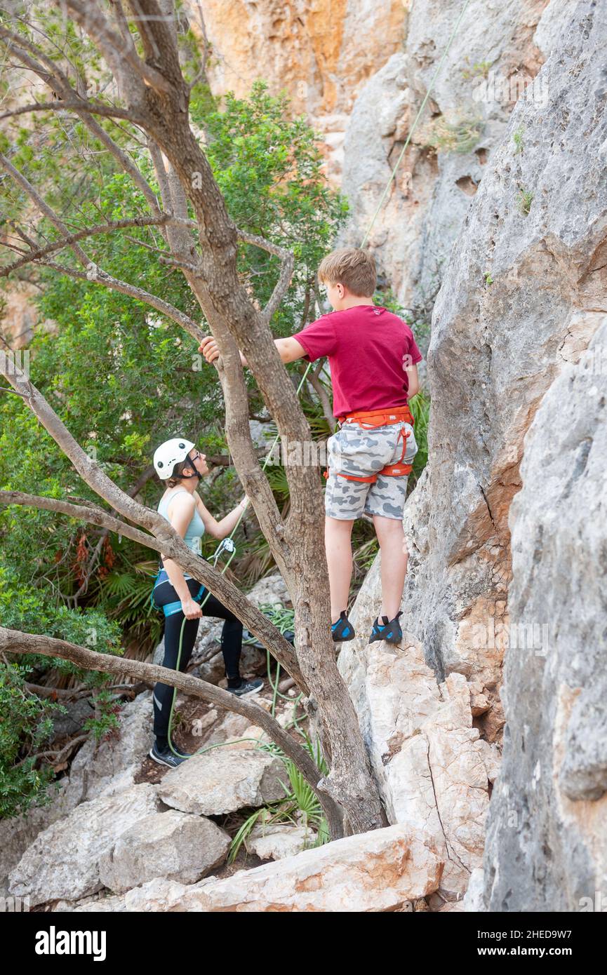 Family rock climbing at Puig de Garrafa climbing area, Andratx, Mallorca, Spain Stock Photo