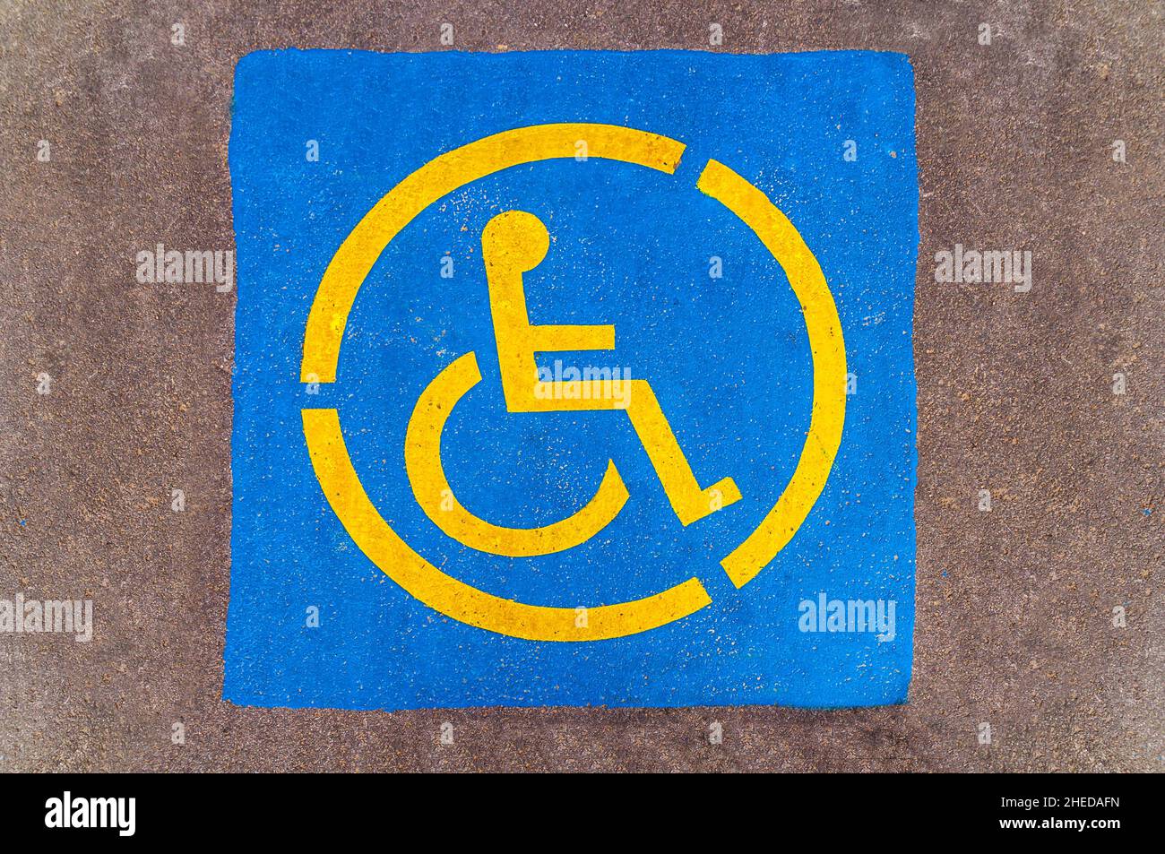 Handicap yellow parking sign on asphalt, persons with disabilities