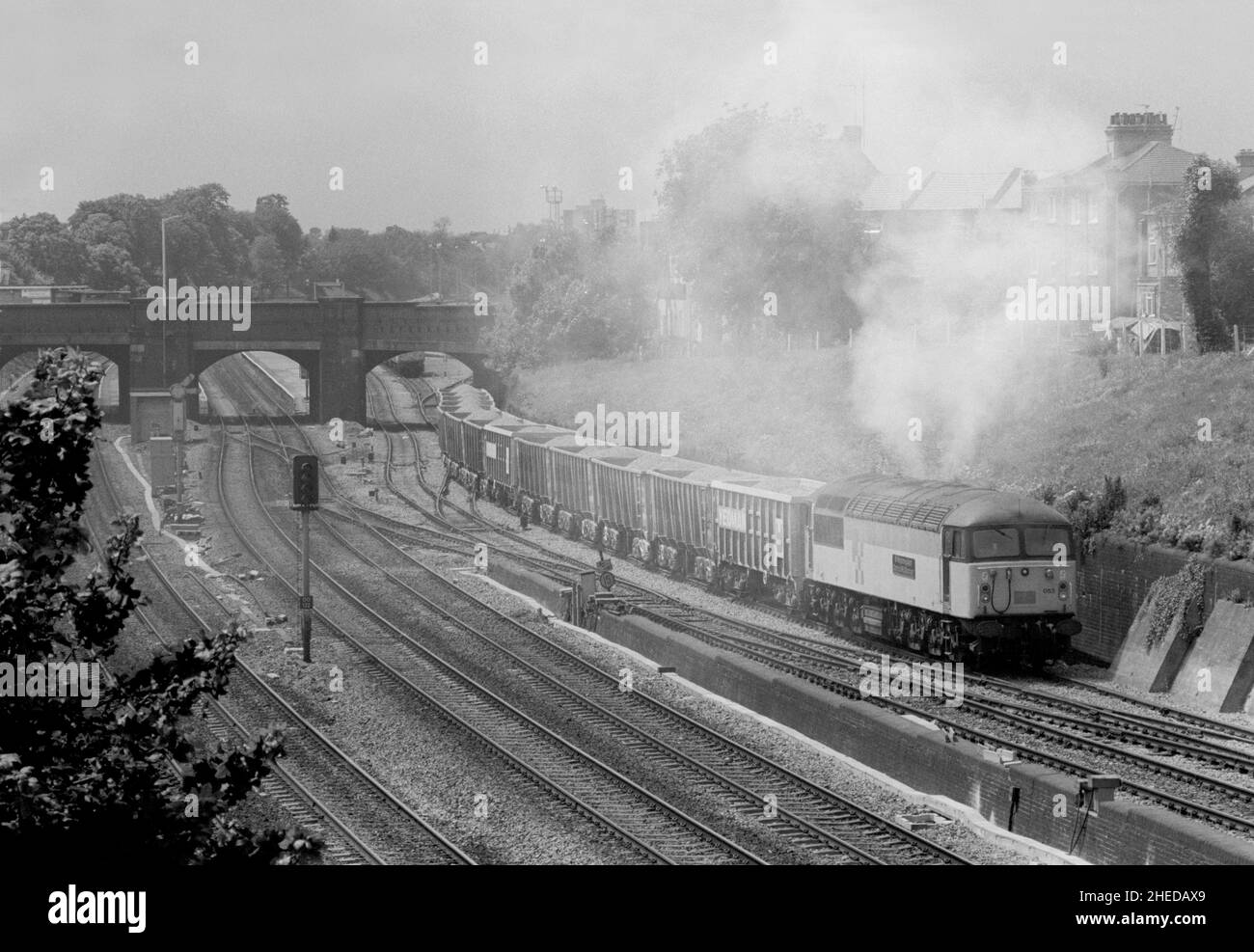 A Class 56 diesel locomotive number 56053 makes a smokey ascent of Acton Bank with a loaded aggregates train on the 10th June 1991. Stock Photo