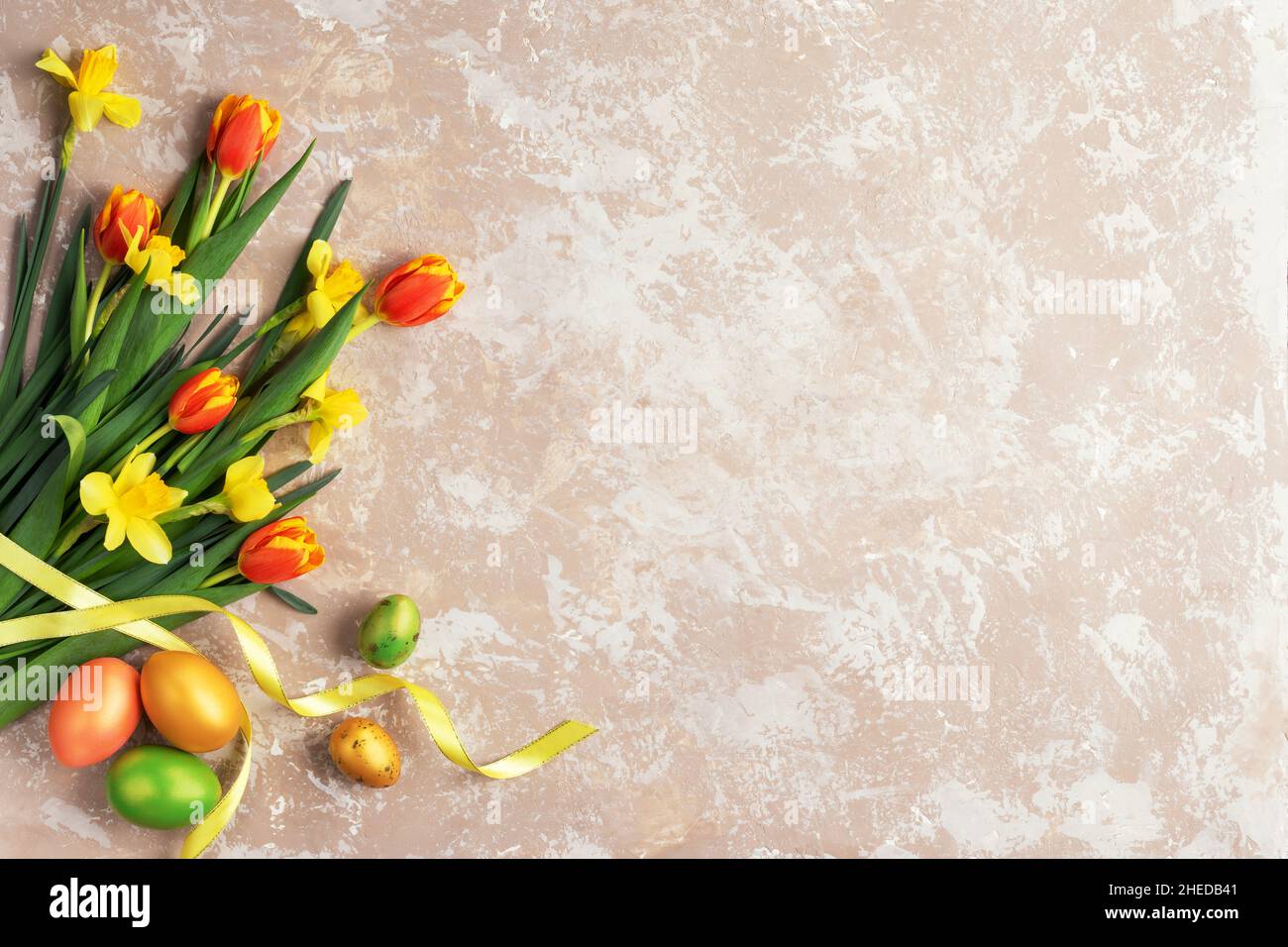 Happy Easter card. Congratulatory easter background. Easter eggs and flowers. Stock Photo